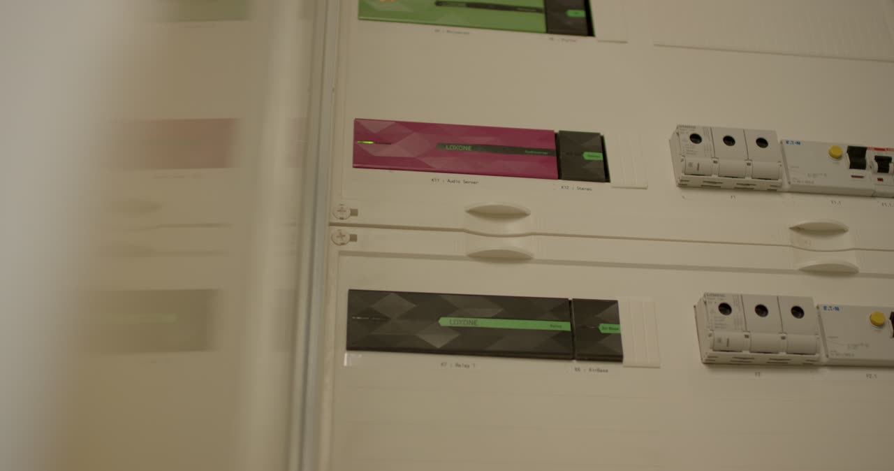 Nahaufnahme von einem modernen Sicherungskasten mit Loxone Smart-Home-Modulen und Status-LEDs